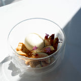 Thermic Sublime Double Wall Dessert Bowl filled with appetizing dessert with figs and cookies finished with little flowers and gold flakes, standing on a white surface