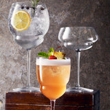 Backdoor '20s Great Gatsby Cocktail Glass standing next to other two cocktail glasses from the collection on a wooden surface