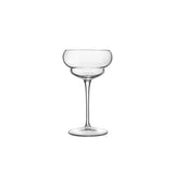 A clear Backdoor '20s Nick & Nora cocktail glass with a stem and a wide bowl, designed for serving cocktails on a white background
