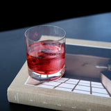 Glass with non-alcoholic cocktail on a book with a dark background