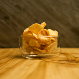 Sublime Thermic double-wall bowl filled with chips standing on a wooden table with a dark background