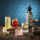 Four Top Class glasses filled with different colorful cocktails standing on a wooden table or books, the décor is mixology inspired with different tools.