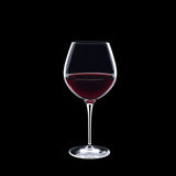 Vinoteque Robusto Red Wine Glass filled with red wine on a black background