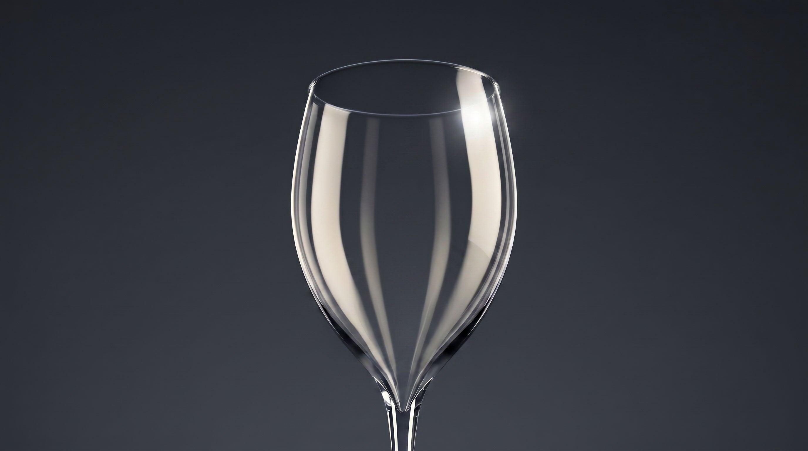 Clear wine glass on a dark gray background