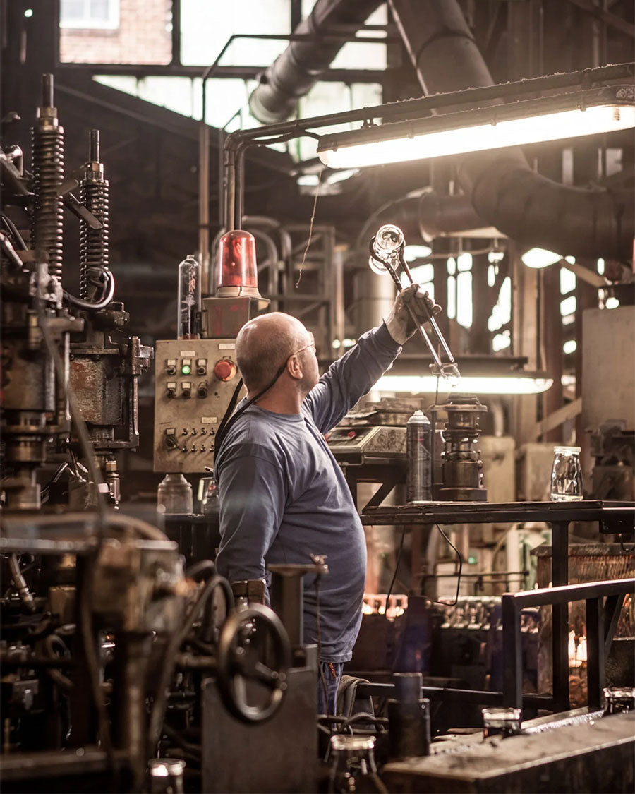 Man working in a factory setting with machinery and equipment around