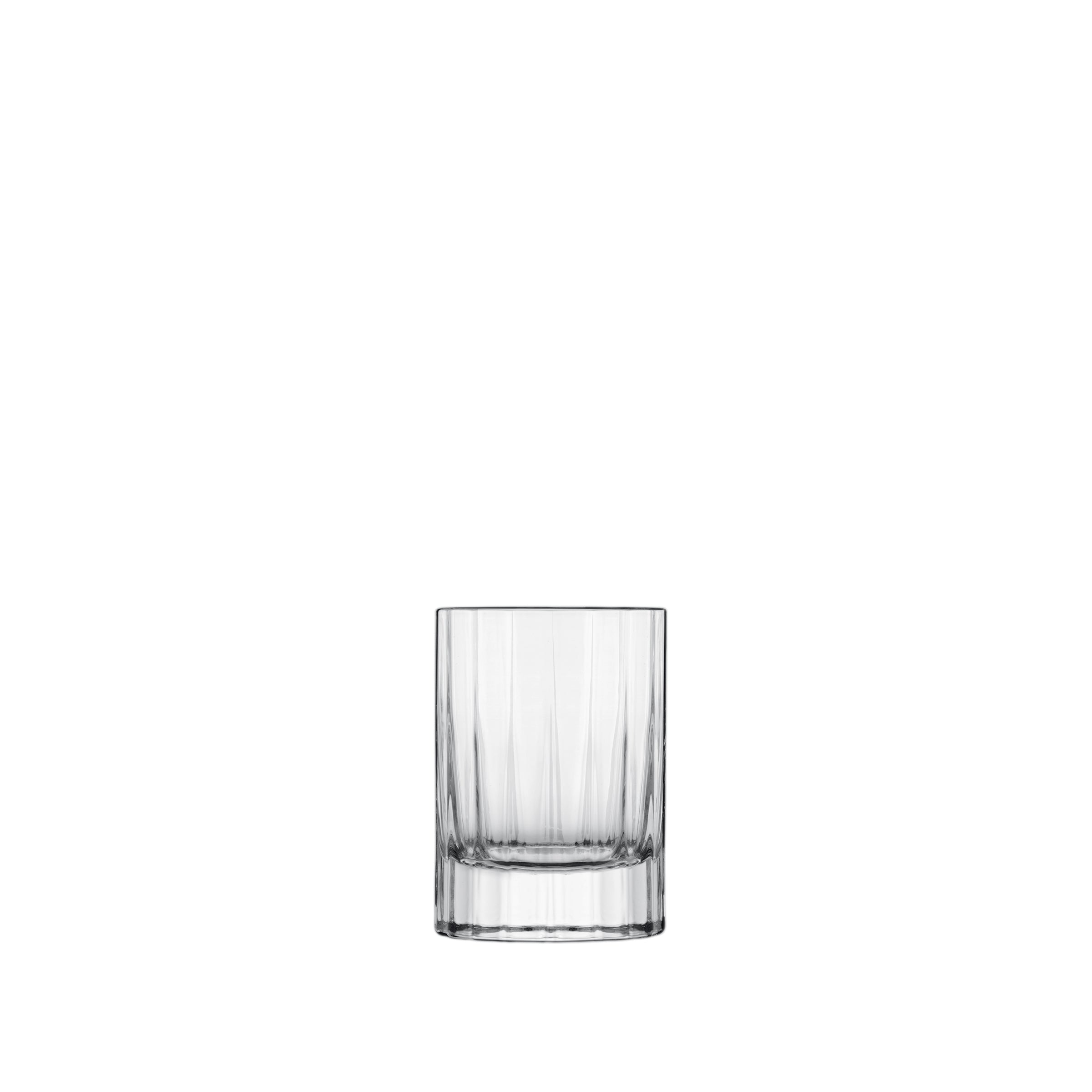 A clear, faceted, round, retro-style Bach shot glass with a thick base.