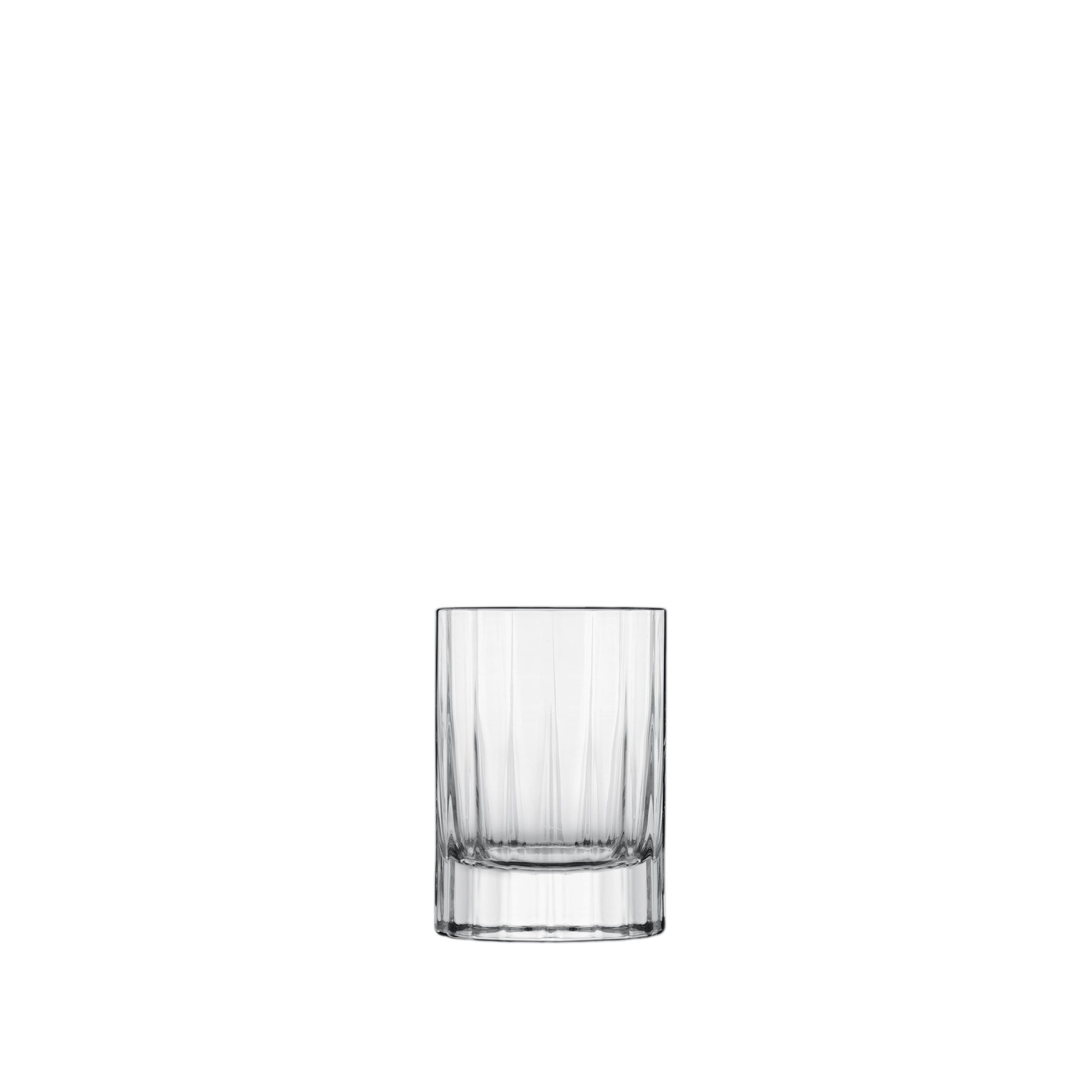 A clear, faceted, round, retro-style Bach shot glass with a thick base.
