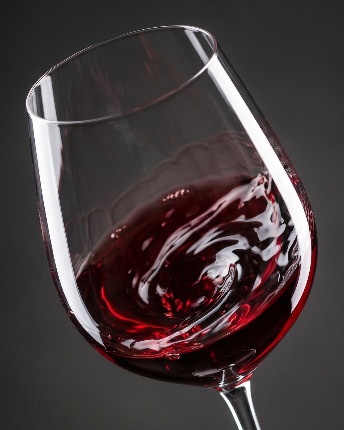 Glass of red wine on a dark background