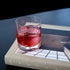 Glass with non-alcoholic cocktail  on a book with a dark background