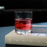 Glass with non-alcoholic cocktail  on a book with a dark background