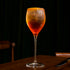 Spritz cocktail in a Magnifico Small wine glass on a dark background