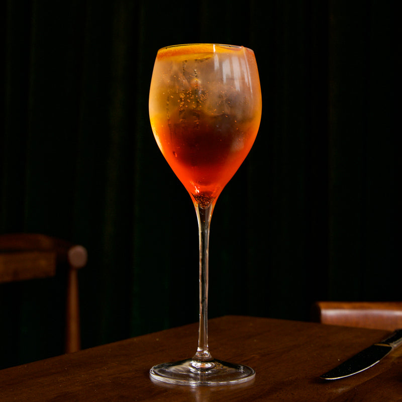Spritz cocktail in a Magnifico Small wine glass on a dark background