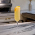 Cocktail in a tall glass with a blurred kitchen background