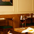 Supremo Bordeaux wine glass on a table filled with red wine in a cozy restaurant setting