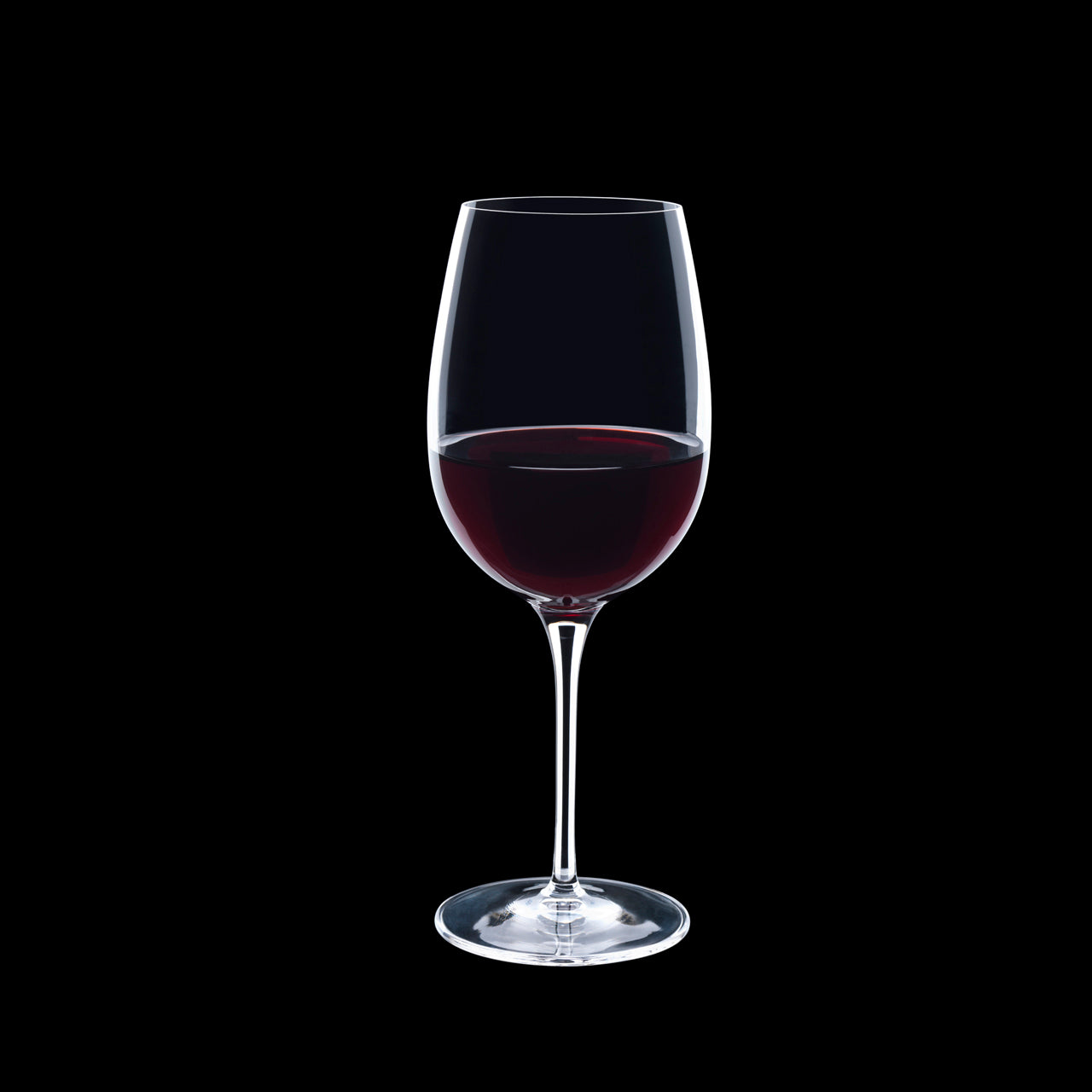 Vinoteque Ricco Red Wine Glass filled with red wine on a black background
