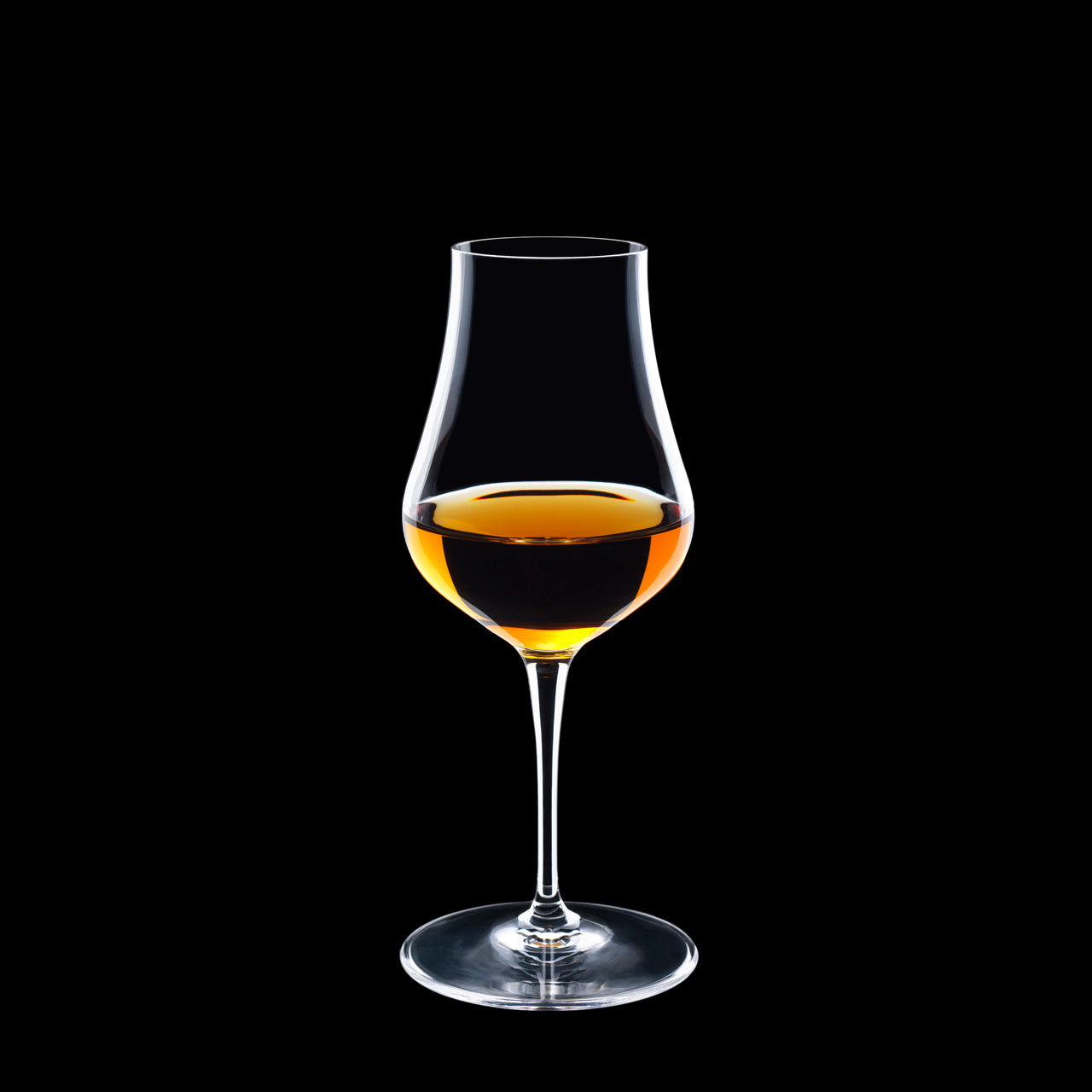 Vinoteque Snifter glass filled with a spirit on a black background