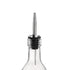 A close-up of a clear glass bottle with a silver stainless steel pourer attached to its top.