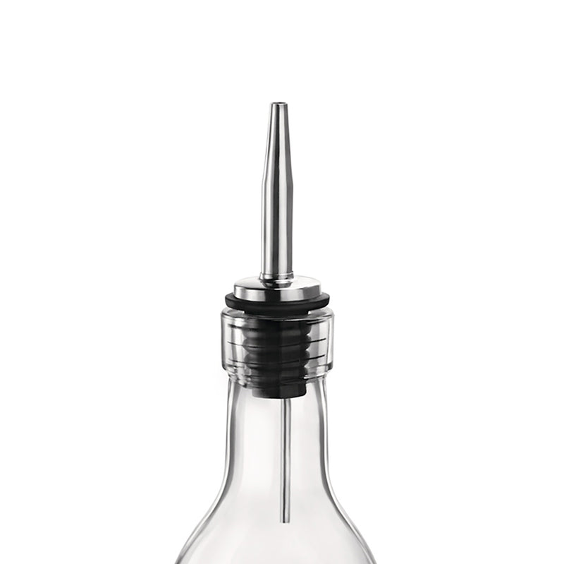 A close-up of a clear glass bottle with a silver stainless steel pourer attached to its top.
